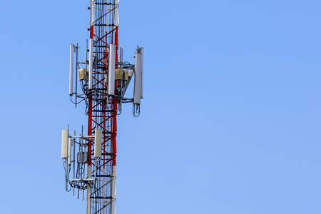 Telecommunication tower on blue sky for web backgroundの写真素材