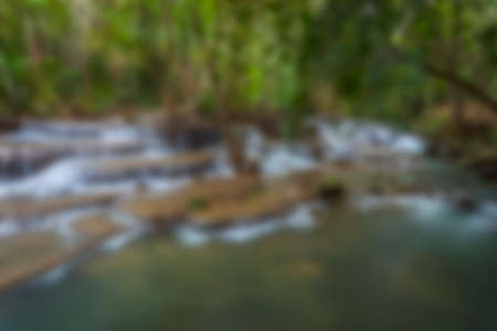 Blurred waterfall background in tropical forest in thailandの写真素材