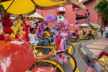 MELAKA MALAYSIA  November 04 2012: Unidentified man ride trishaw a blooming vehicle on the road on November 04 2012 in MelakaMalaysiaのeditorial素材