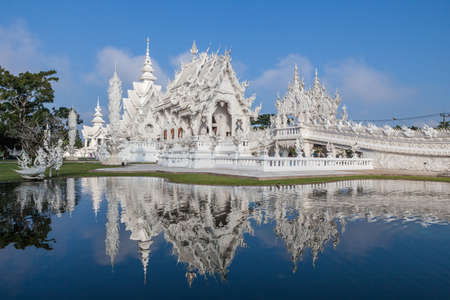 Magnificently grand white church and reflection in the water, Rong Khun temple, Chiang Rai province, northern Thailandの写真素材