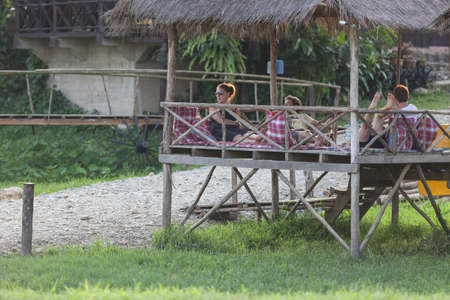 VANG VIENG, LAOS - 7 december 2012: Cottages for tourists to relax, eat and drink.のeditorial素材