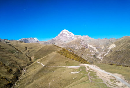 Mountains of Georgia. Kazbegi. Summer day. Road. Travel to the mountains.