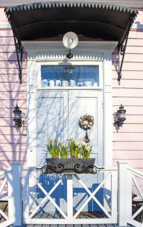 Entrance door. Easter wreath. The porch of the house. Frontal side of the house.の写真素材
