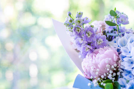 Bouquet of flowers close-up. Joyful mood, a gift from a loved one. Summer flowers. Peonies, hydrangea and others. Soft focus.の写真素材