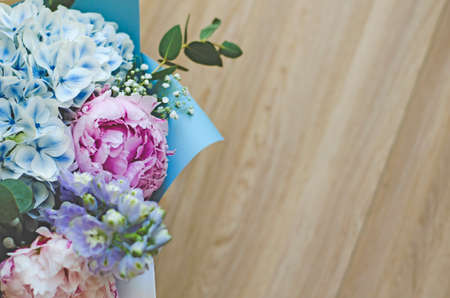 Bouquet of flowers close-up. The view from the top. Standing on the floor, tree. Summer flowers. Peonies, hydrangea and others. Soft focus.の写真素材