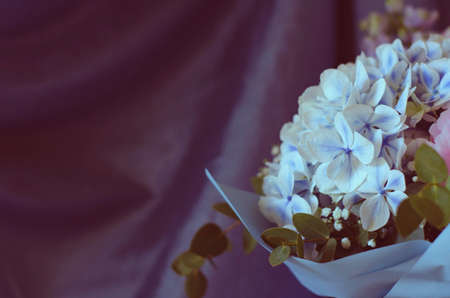 Bouquet of flowers close-up. On a blue background. Still-life. Summer flowers. Peonies, hydrangea and others. Soft focus.の写真素材