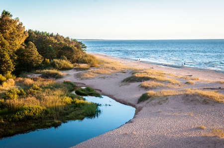 peaceful evening walking along the beautiful seasideの写真素材