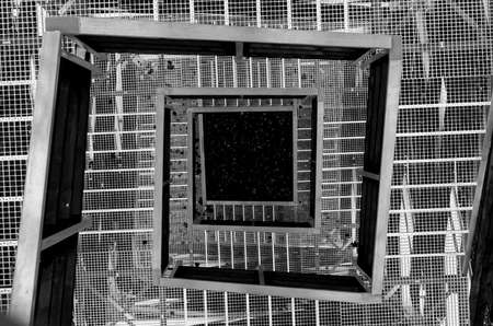 Looking down from tower stairs made from metal and woodの写真素材