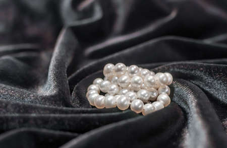 Beautiful pearl necklace on the black velvetの写真素材