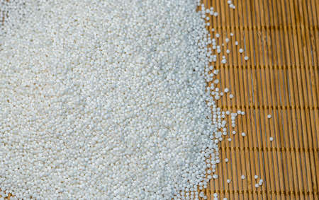 Background - raw tapioca seedson the wooden matの写真素材