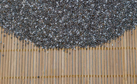 Background - raw chia seeds on the wooden mat - macroの写真素材