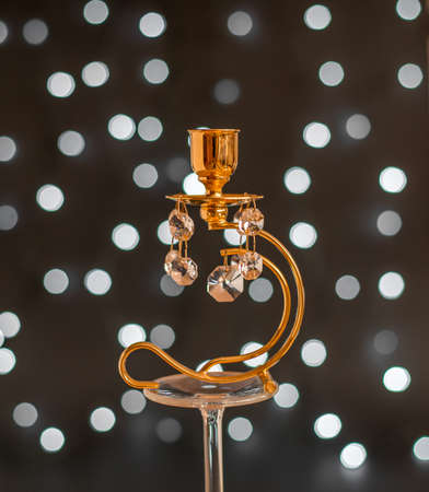 Abstract - golden candlestick with crystals and lights on black backgroundの写真素材