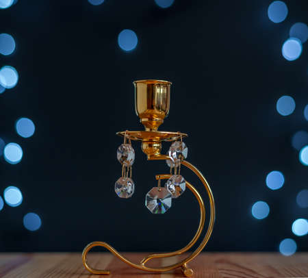 Abstract - golden candlestick with crystals and blue lights on black backgroundの写真素材