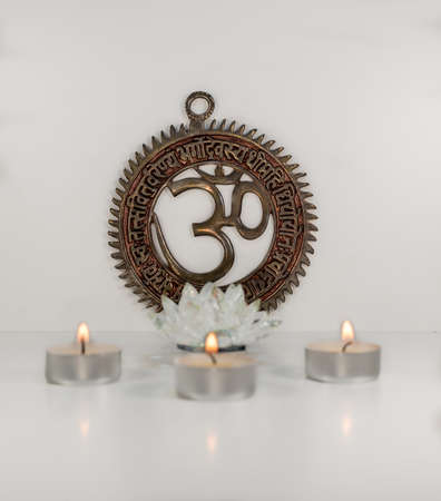 Om sign with crystal lotus burning candles - Indian special mantra - white backgroundの写真素材