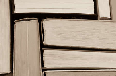 Abstract - stack of old books side view - sepia backgroundの写真素材