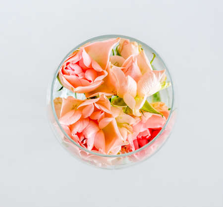 Glass with small rose flowers wedding celebration white backgroundの写真素材