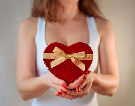 Red heart present woman hands holding - Valentine day romantic surpriseの写真素材