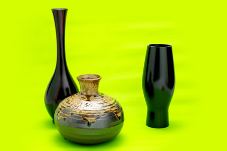 set black antique ceramic vase. empty decorative ceramic pot on green background. brown modern porcelain vase for room interior. vintage handmade glaze pottery flowerpot office decoration collectionの写真素材