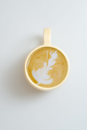 Coffee cup of cappuccino with latte art isolated on white background. Beautiful hot heart foam...