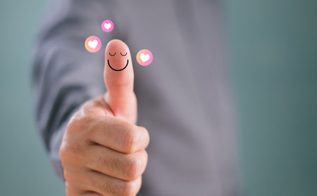 Customer experience compliment concept. Thumb up happy smile face, good feedback rating positive customer review, mine satisfaction survey, mental health assessment, feeling good mental health dayの写真素材