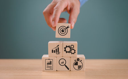 Goal setting planning focus for future. Goal aim target concept. Hand push target board on wooden cube block icon for creative set up business success objective. Achievement winner business projectの写真素材