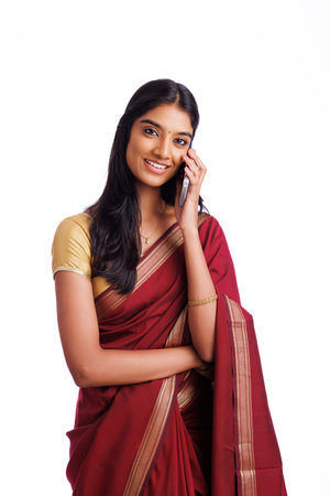 Young Indian woman talking on mobile phone, isolated on white background.の写真素材
