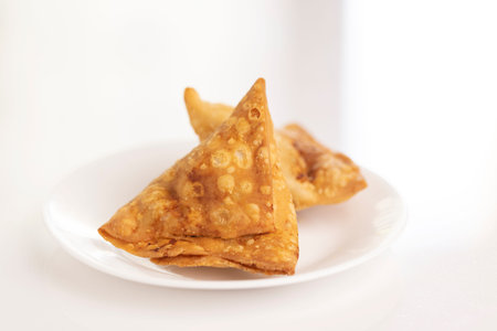 Plate of hot Samosas on table