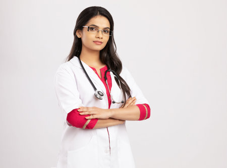Portrait of young female doctor with stethoscope on white backgroundの写真素材