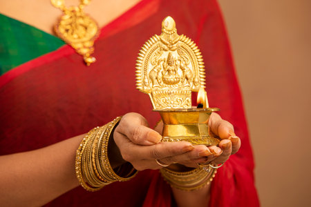 Indian woman holding diwali or deepavali oil lamp in handの写真素材