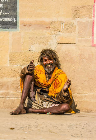 A sadhu, or holy man, sitting on the ghats of the holy hindu city of Varanasiのeditorial素材