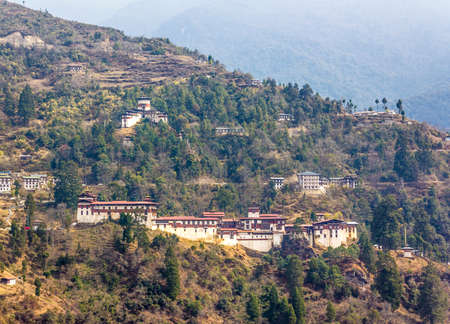 The beautiful dzong of Trongsa, Bhutan  Above the dzong in the mountains is the watchtower, now a museum  Dzongs are fortress like buildings that house a monastery and administration offices のeditorial素材