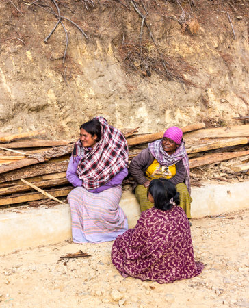 Three female workers are taking a break from the hard work at the highway of Bhutan のeditorial素材