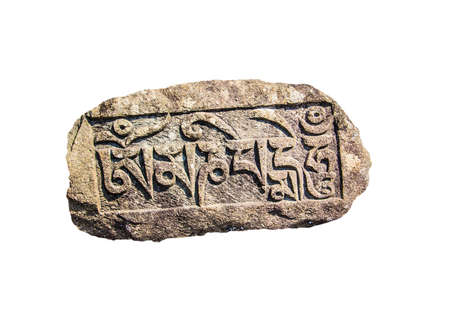A mani stone at from Tashiding, Sikkim, India. The stone is engraved with a buddhist prayer in tibetan script.Isolated on white.のeditorial素材