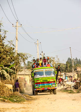 A lokal bus at the outskirts of Janakpur, Nepal  People are sitting on the roof of the bus  Janakpur is situated in the south of Nepal のeditorial素材