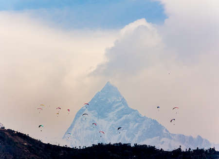 Paragliders around the fish tail peak (machhapuchhre) near Pokhara, Nepal.の写真素材