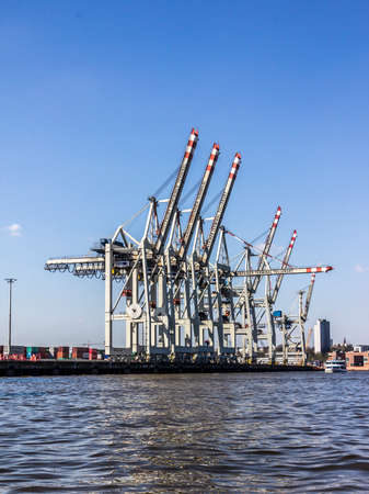 A container terminal in the harbor of hamburg, Germany. A ship lies not more than one day in the terminal.のeditorial素材