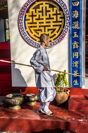 A chinese monk in a chinese temple near Fang, is cleaning the floor.のeditorial素材