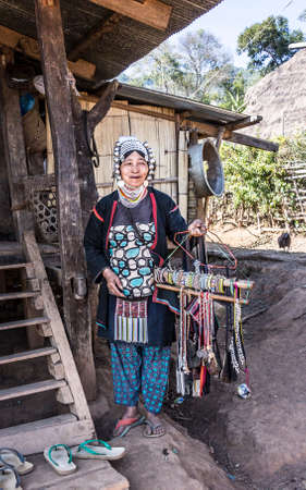 Woman of the Akha tribe in the hills near keng Tung is selling her goodsのeditorial素材
