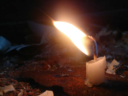 burning candle in the corner of the yardの写真素材