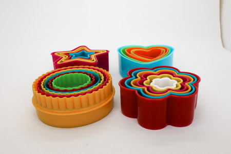 Star, rose and heart shaped cake molds isolated on whiteの写真素材