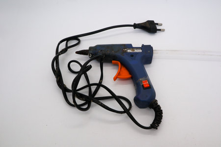 Hot glue is a type of glue that has stronger adhesive qualities and is long-lasting in whiteの写真素材