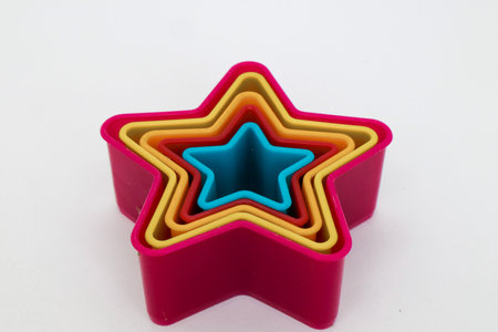 Star, rose and heart shaped cake molds isolated on whiteの写真素材