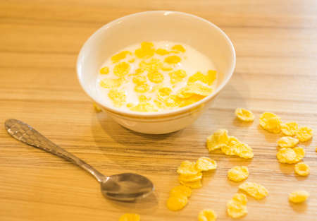 a small Cup of milk with grains is on the tableの写真素材