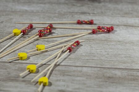 skewers for canapes lying on a wooden tableの写真素材