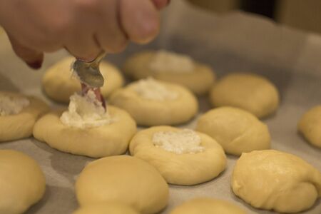 girl makes of buns on the table, hands, close-upの写真素材