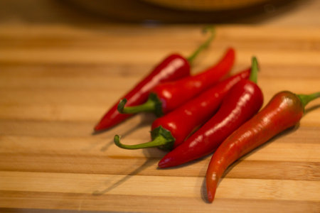 red chili pepper lying on a wooden table