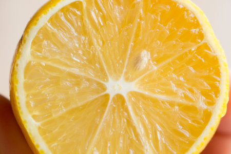 a lemon cut on wooden table, close-up
