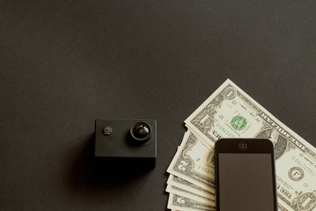 paper money and a mobile phone lying on a black backgroundの写真素材