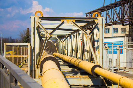 yellow gas pipes are run through the bridge