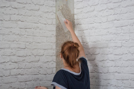 woman doing wall repairs